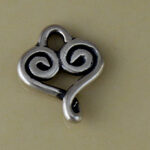 Silver spiral heart charm on beige background
