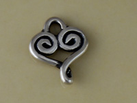 Silver spiral heart charm on beige background