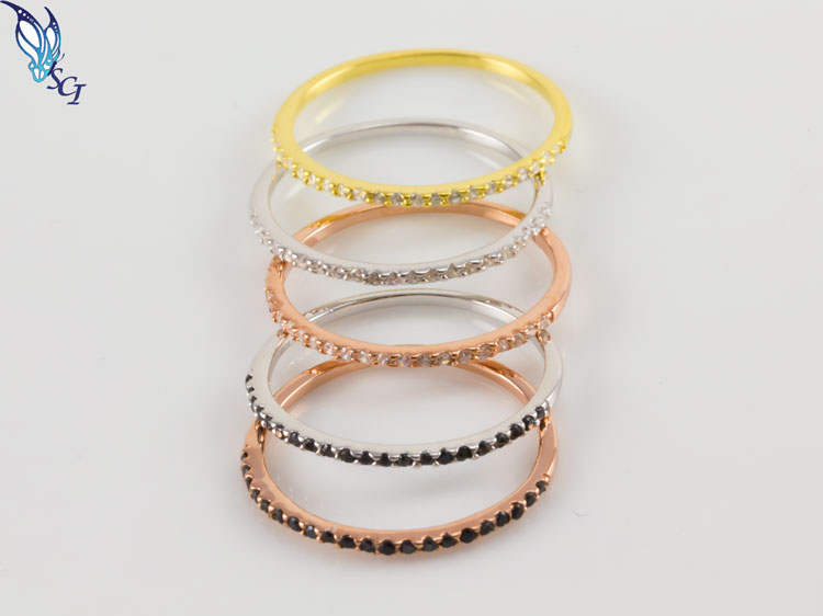 Stacked gold, silver, and rose-gold rings with stones Stacked gold, silver, and rose-gold rings with stones