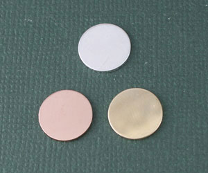 Three circular cosmetic pads on green background