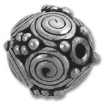 ornate metal bead with spiral and dot patterns