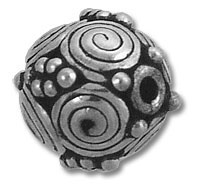 ornate metal bead with spiral and dot patterns